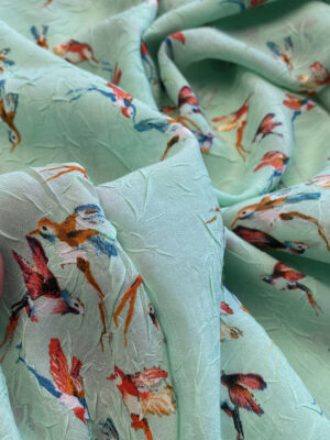 Шифон жатий ментолового кольору з маленькими колібрі