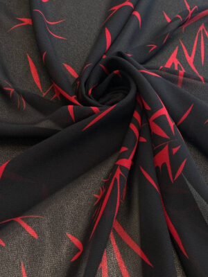 Шифон креп чорного кольору з тонкими абстракційними листями темно-червоного кольору