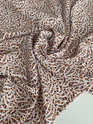 Штапель віскозний мереживний дизайн з помаранчево-жовтих квіточок на світлому фоні