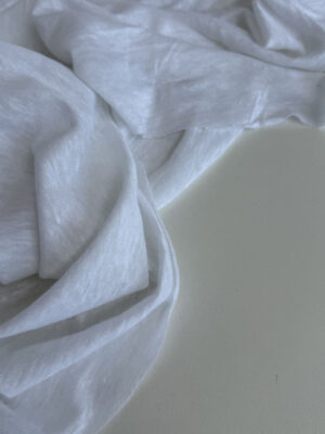 Льон трикотажний білого кольору напівпрозорий з рисочками